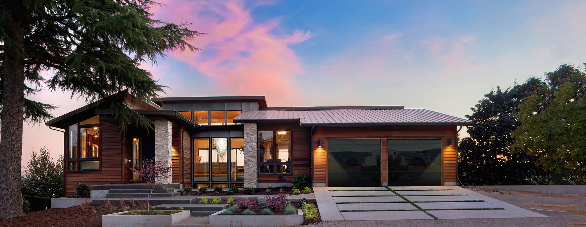 Modern residential home at sunset with a sleek glass-panel garage door, providing a blend of contemporary style and functionality. Ideal for Utah homeowners seeking premium, stylish garage door solutions.
